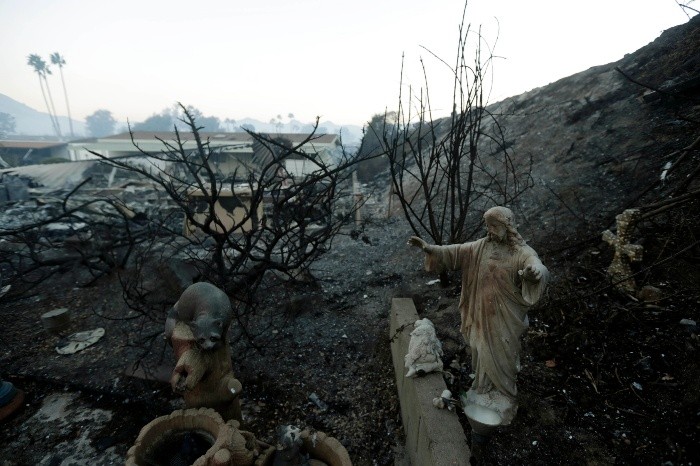 A statue sits among destroyed homes in the Rancho Monserate Country C - A statue sits among destroyed homes in the Rancho Monserate Country Club community Friday, Dec. 8, 2017, in Fallbrook, Calif. The wind-swept blazes have forced tens of thousands of evacuations and destroyed dozens of homes in Southern California. (AP Photo/Gregory Bull) California Wildfires