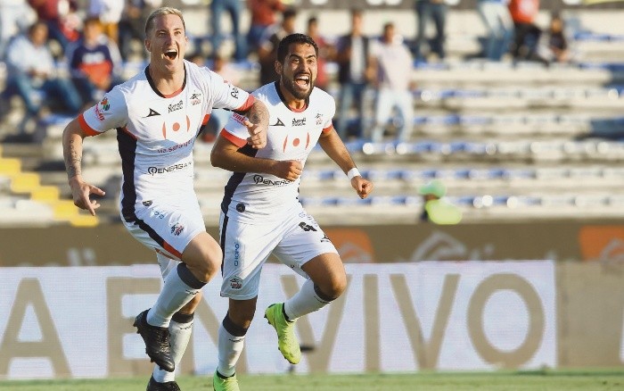 El argentino Leonardo Ramos (izquierda) celebra su gol, primero de Lobos BUAP, acompañado de su compañero José Esquivel. MEXSPORT